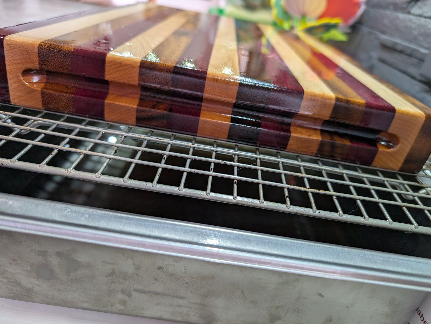 Wooden cutting board showing finger grip